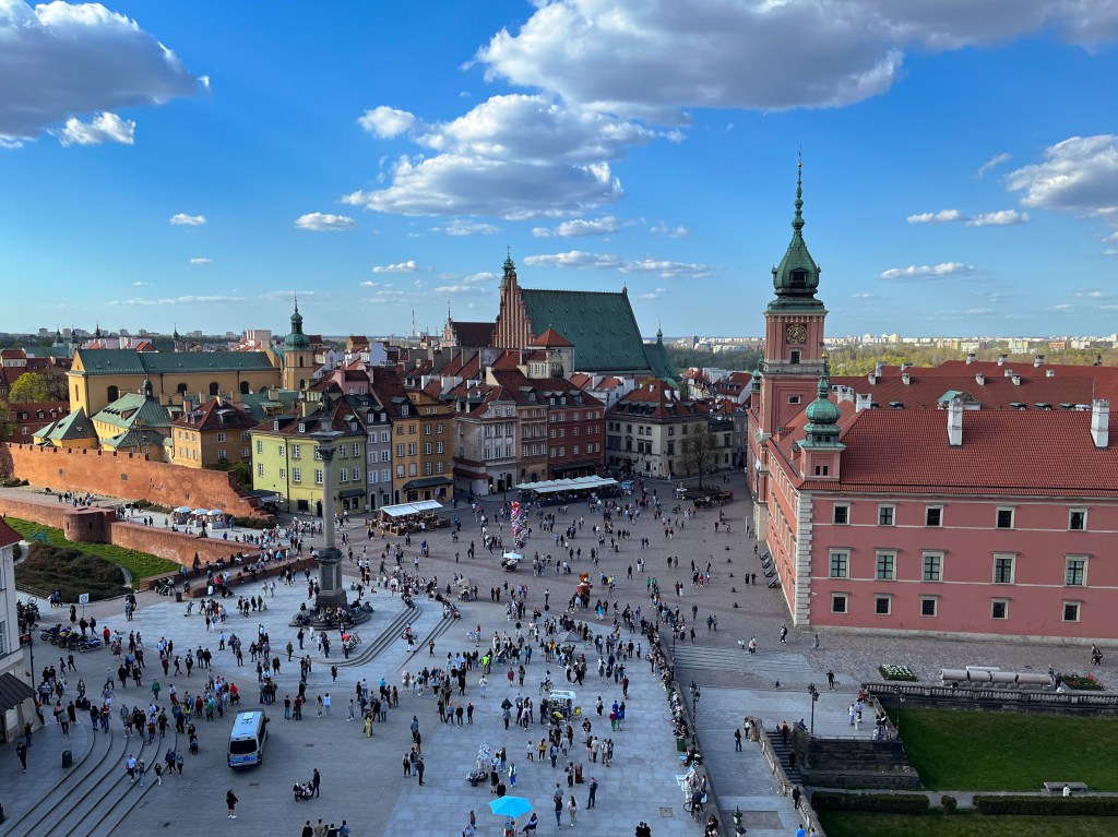 photo of the old town in Warsaw, elevated for a good view of the royal palace and other reconstructed colourful buildings.